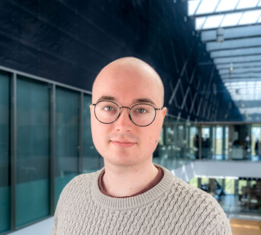 Benjamin Ricketts standing at SRON Leiden's 4th floor for a portrait photo